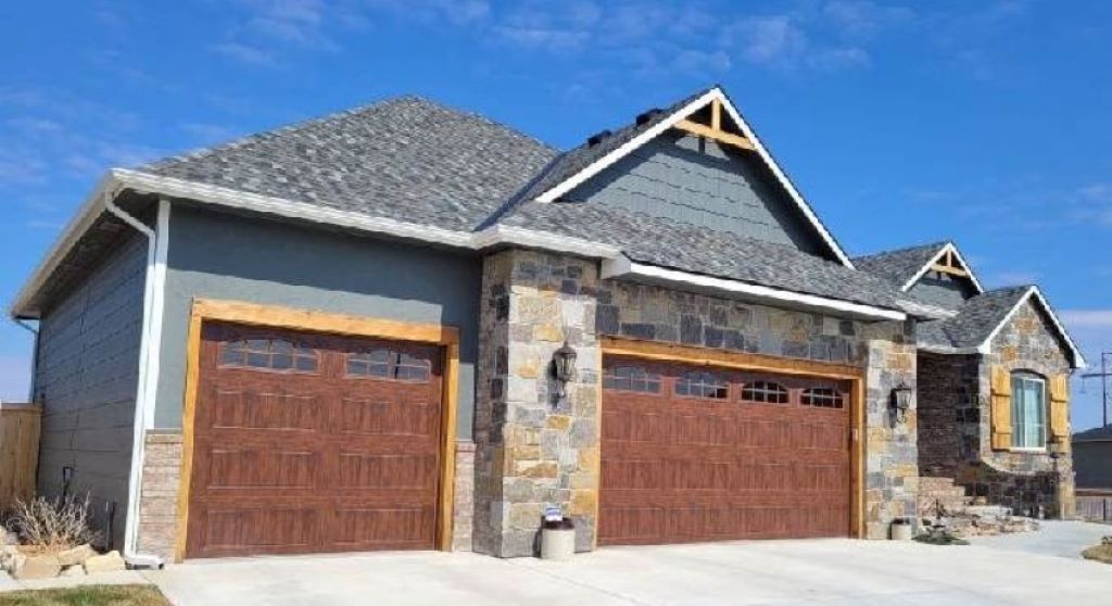 Homeowner inspecting garage door before winter, illustrating the 2025 maintenance checklist