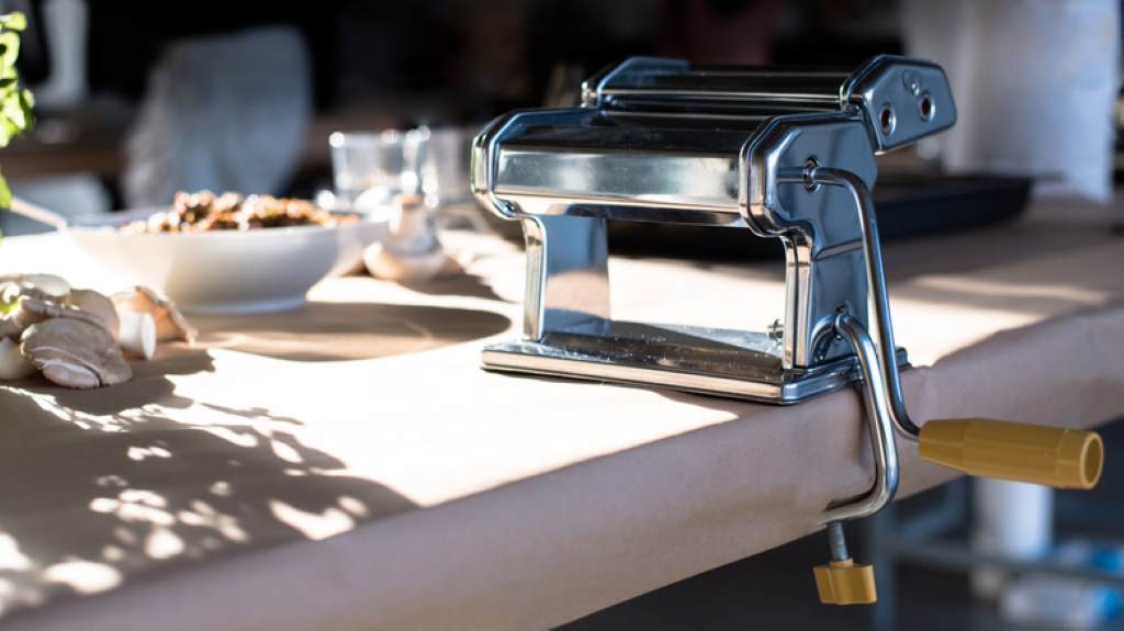 Stainless steel pasta cutters being polished with soft dry cloth after brushing