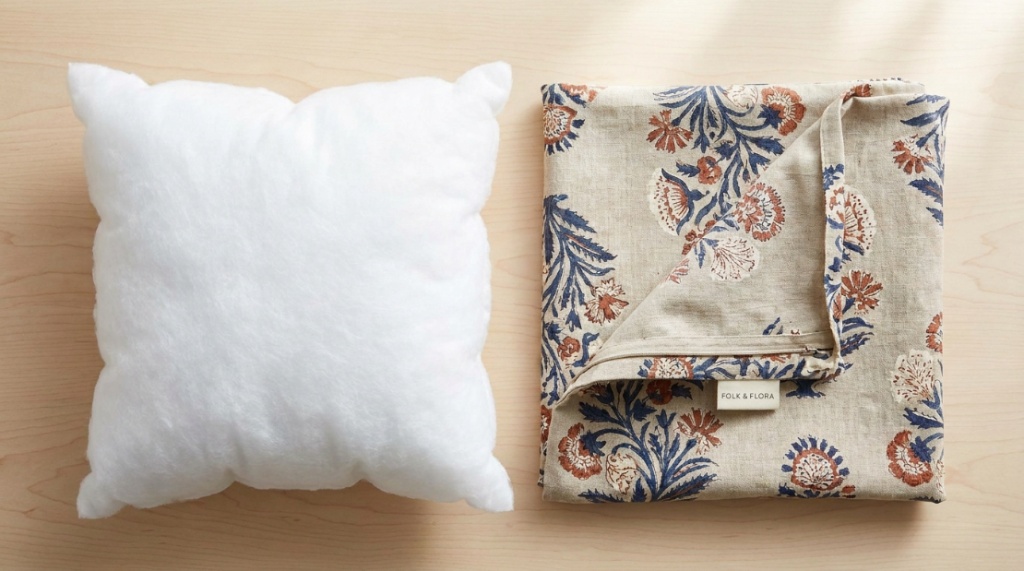 white pillow insert placed beside a colorful decorative pillow cover.